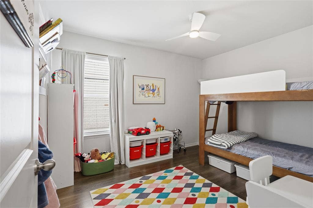1108 Emerald Gate Drive, Princeton, TX 75407 Room featuring wood-finish flooring, a contemporary three-blade ceiling fan with integrated lighting, and a window with horizontal blinds
