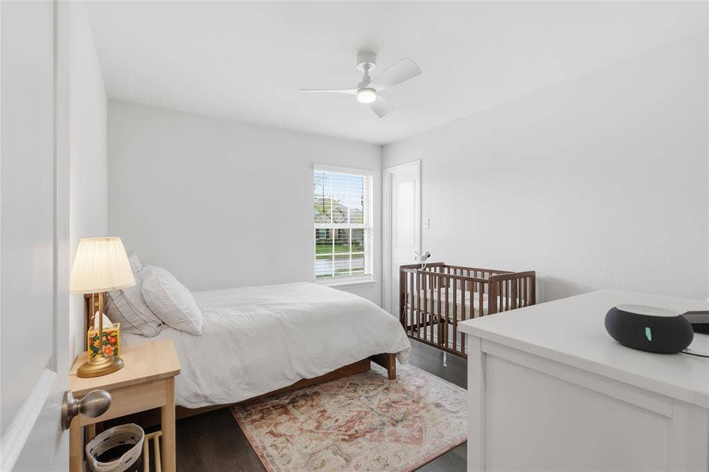 1108 Emerald Gate Drive, Princeton, TX 75407 Neutral interior space featuring wood-finish flooring, a single-hung window with a grid pattern, and a ceiling-mounted light fixture with an integrated fan