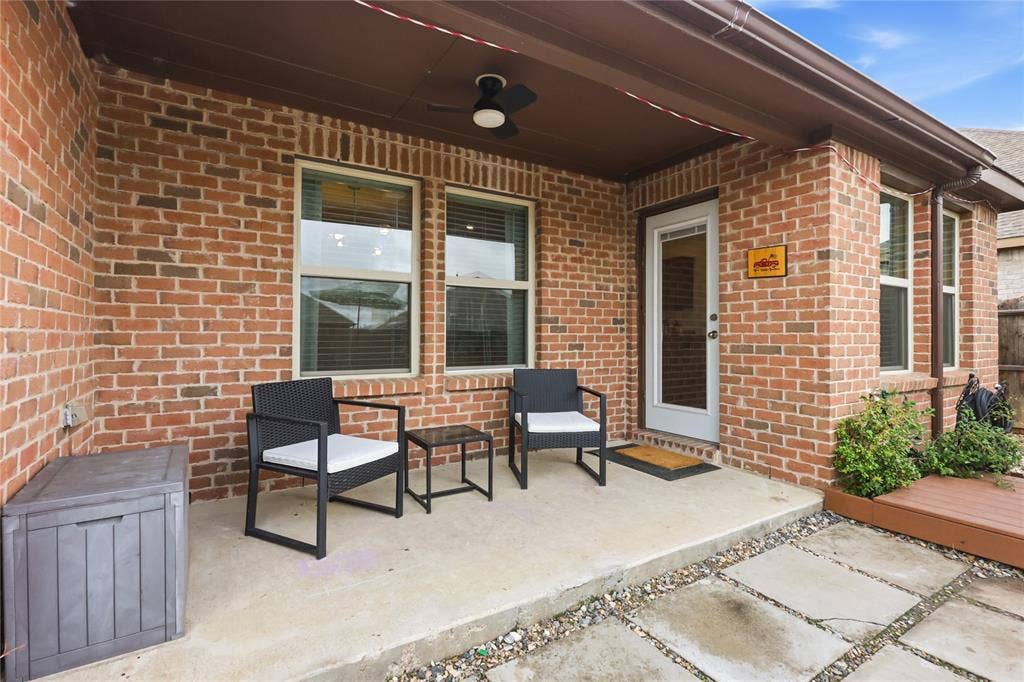 1108 Emerald Gate Drive, Princeton, TX 75407 Covered brick patio featuring a concrete floor, ceiling fan, and multi-pane window configuration
