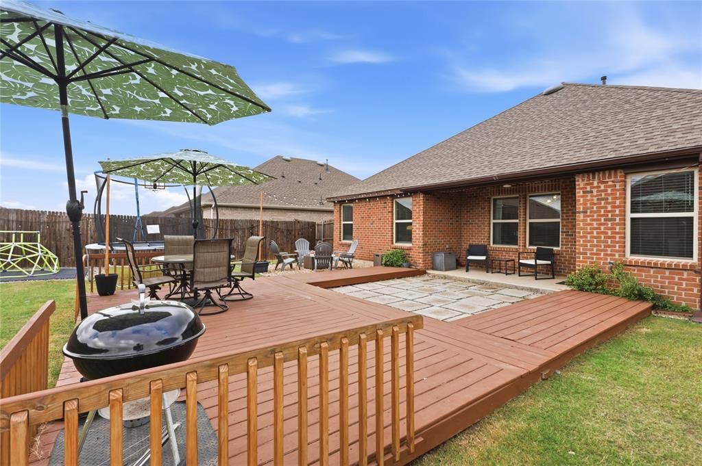 1108 Emerald Gate Drive, Princeton, TX 75407 Multi-level wood deck, stone-paver patio area, and brick exterior finish