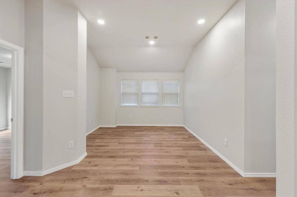 2004 Athabasca Falls Drive, Anna, TX 75409 Vaulted ceilings featuring recessed lighting, neutral wall finishes, and wood-finish flooring with three windows