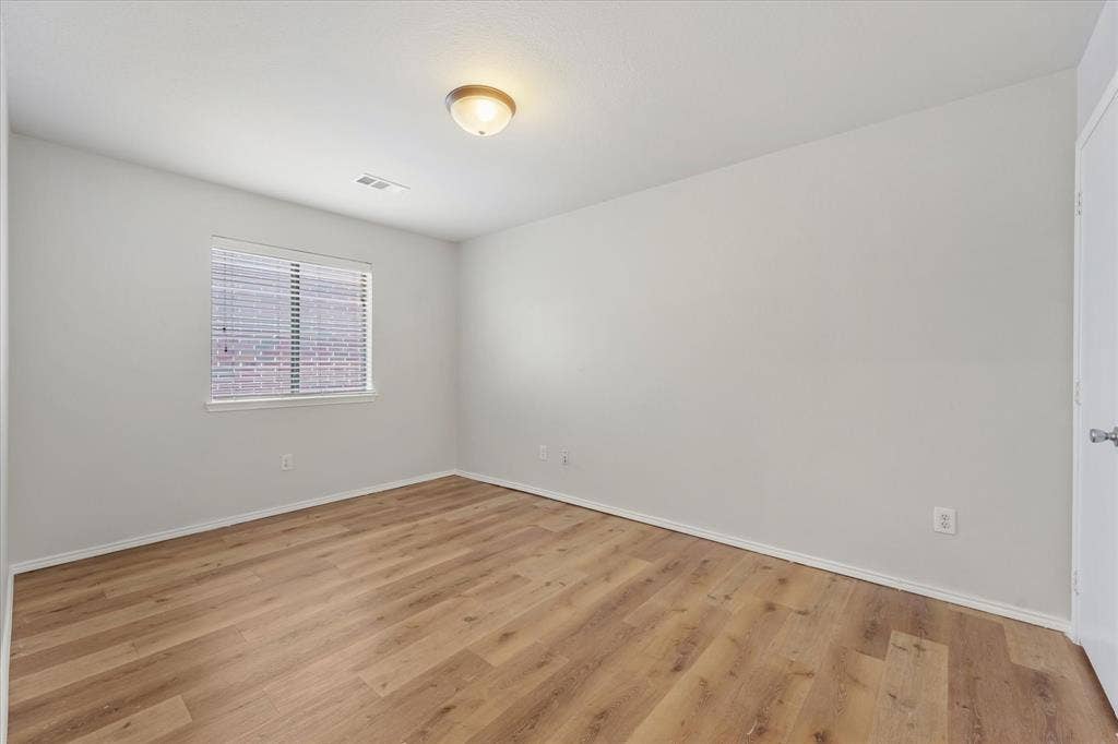2004 Athabasca Falls Drive, Anna, TX 75409 Neutral-toned walls, wood-finish flooring, and a single-pane window
