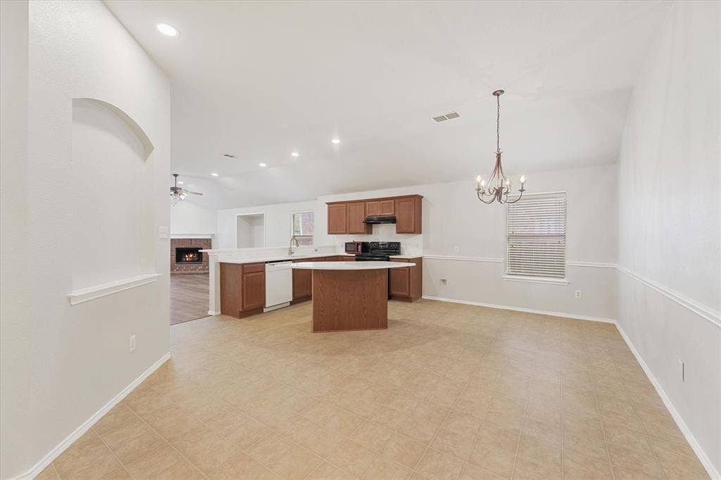 2004 Athabasca Falls Drive, Anna, TX 75409 Kitchen featuring wood cabinetry, a central island with a white countertop, recessed lighting, and a multi-light chandelier