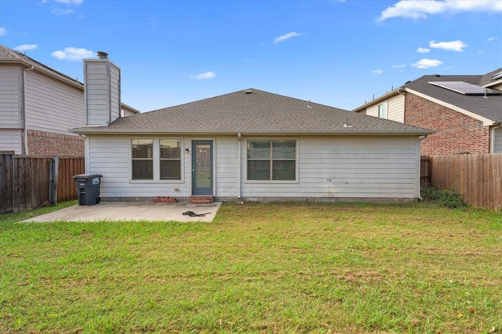 2004 Athabasca Falls Drive, Anna, TX 75409 Rear exterior featuring horizontal lap siding, a concrete patio, a tall exterior chimney, and a fenced backyard