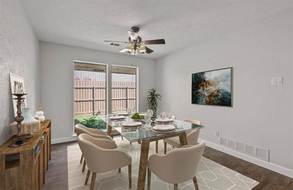9712 Summerhill Lane, Dallas, TX 75238 Neutral interior space featuring wood-finish flooring, dual windows providing exterior exposure, and a ceiling-mounted light fixture with a central fan