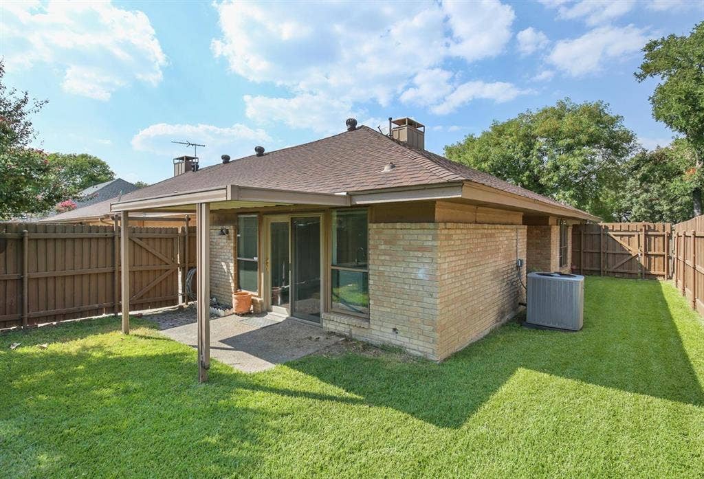 9712 Summerhill Lane, Dallas, TX 75238 Brick exterior, covered patio, fenced backyard, and shingle roof