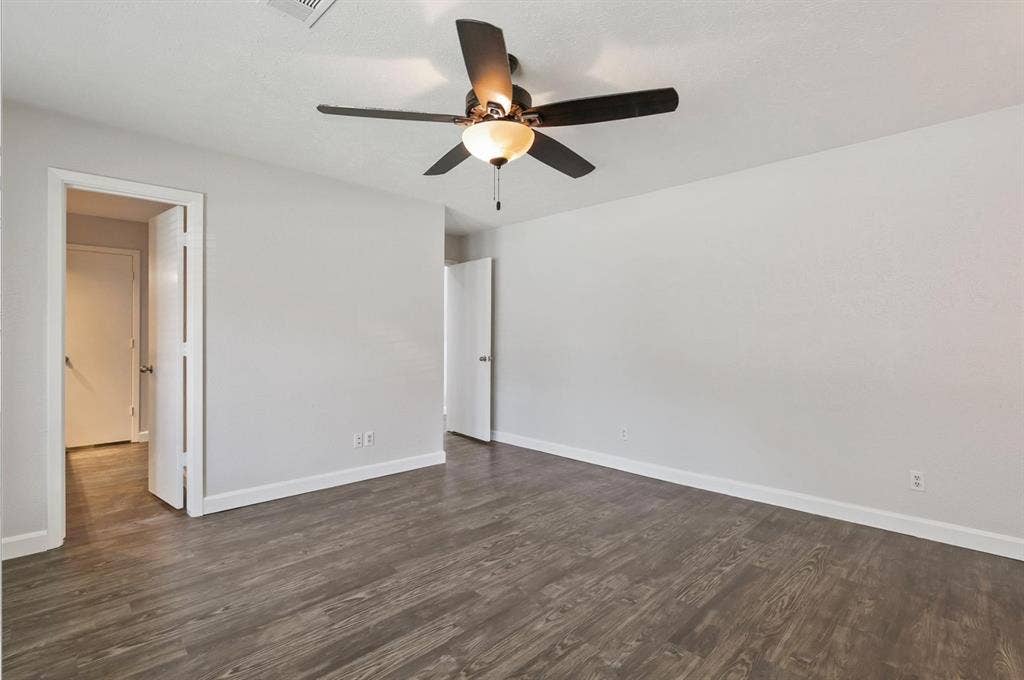 9712 Summerhill Lane, Dallas, TX 75238 Wood-finish flooring, neutral wall tones, and a ceiling fan with integrated light fixture