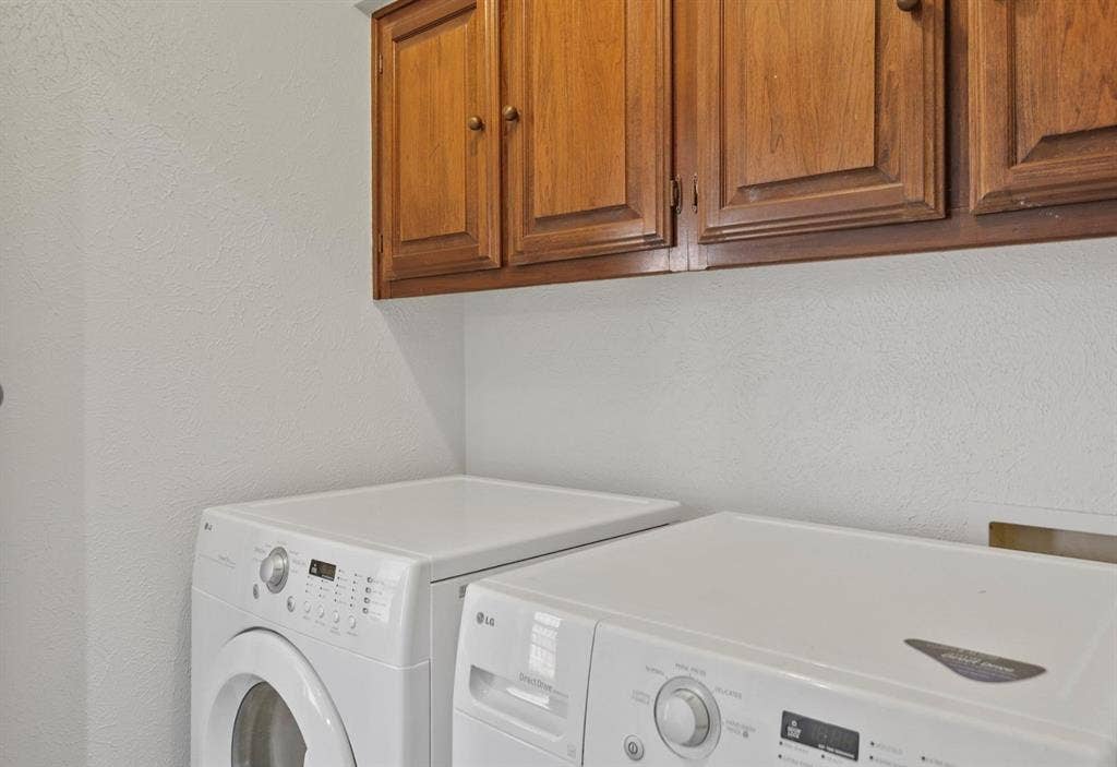 9712 Summerhill Lane, Dallas, TX 75238 Wall-mounted wood cabinetry featuring recessed-panel doors and round hardware
