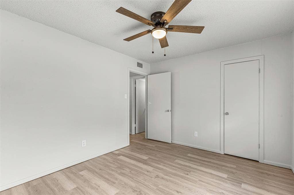Unfurnished bedroom with light wood-type flooring and ceiling fan