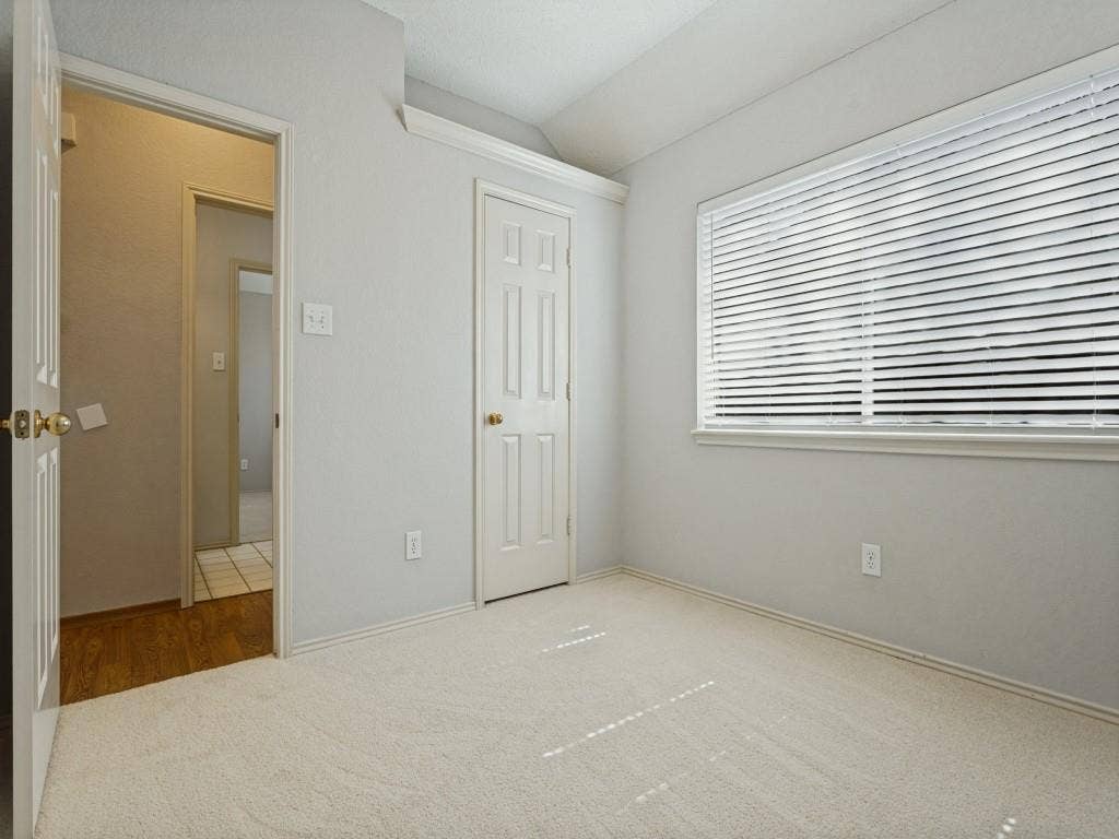2206 Jasmine Lane, Garland, TX 75044 Neutral interior room featuring neutral-toned carpeting, a horizontal window with slatted blinds