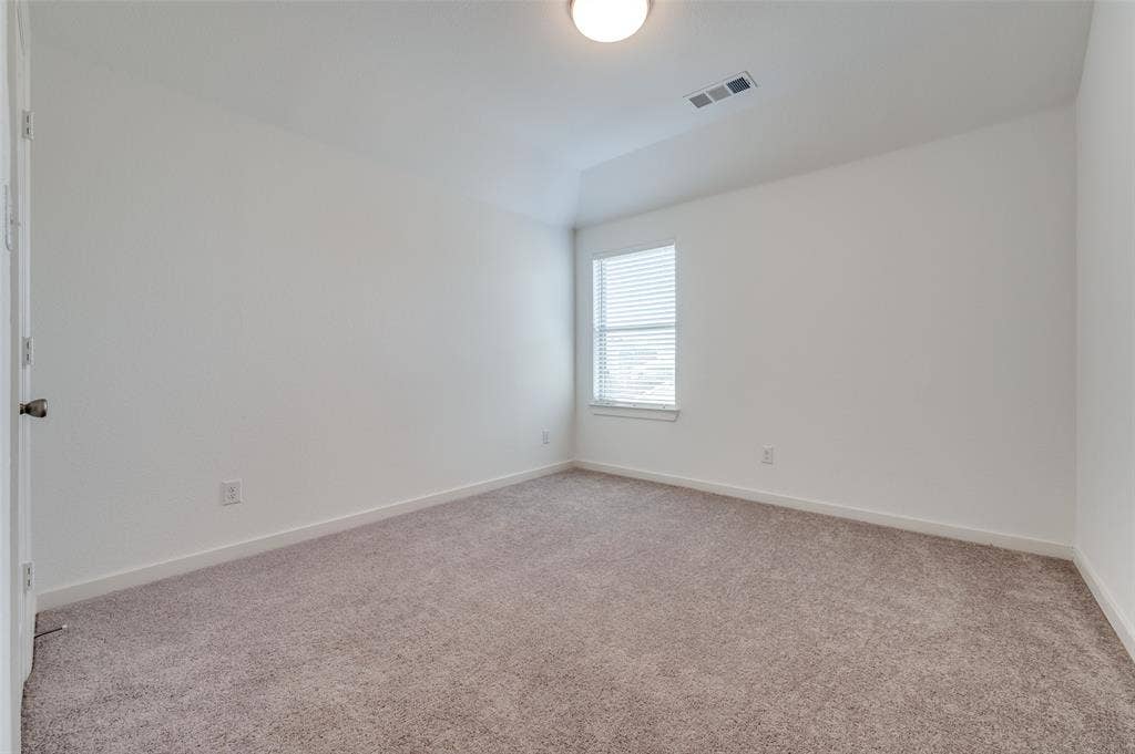 1520 Gelding Drive, Aubrey, TX 76227 Empty room featuring light carpet and baseboards