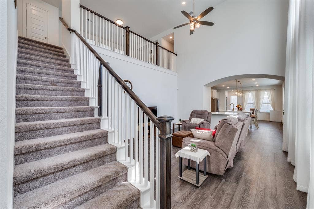 1520 Gelding Drive, Aubrey, TX 76227 Living room featuring wood finished floors, arched walkways, a high ceiling, recessed lighting, and ceiling fan
