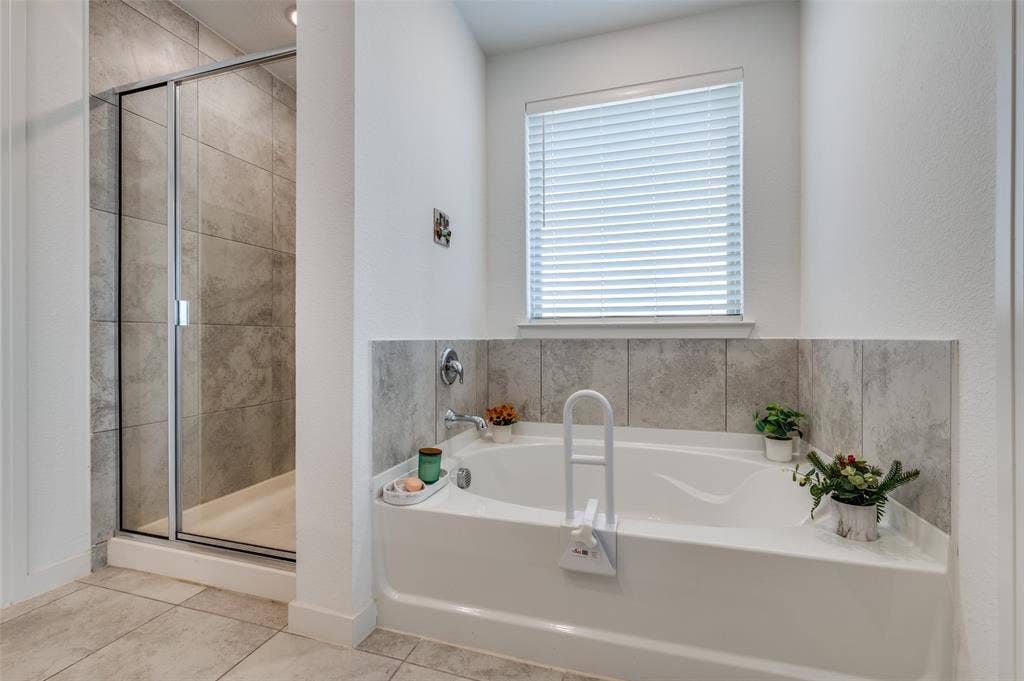 1520 Gelding Drive, Aubrey, TX 76227 Full bath with a shower stall, a garden tub, and tile patterned flooring
