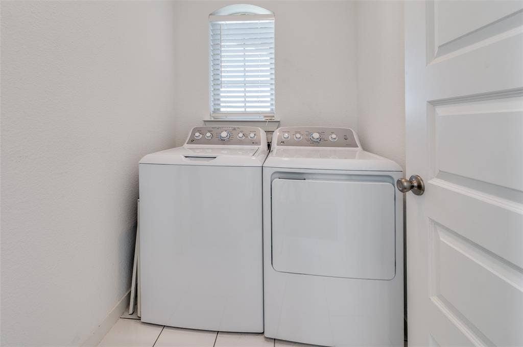 1520 Gelding Drive, Aubrey, TX 76227 Washroom with light tile patterned floors and washer and clothes dryer