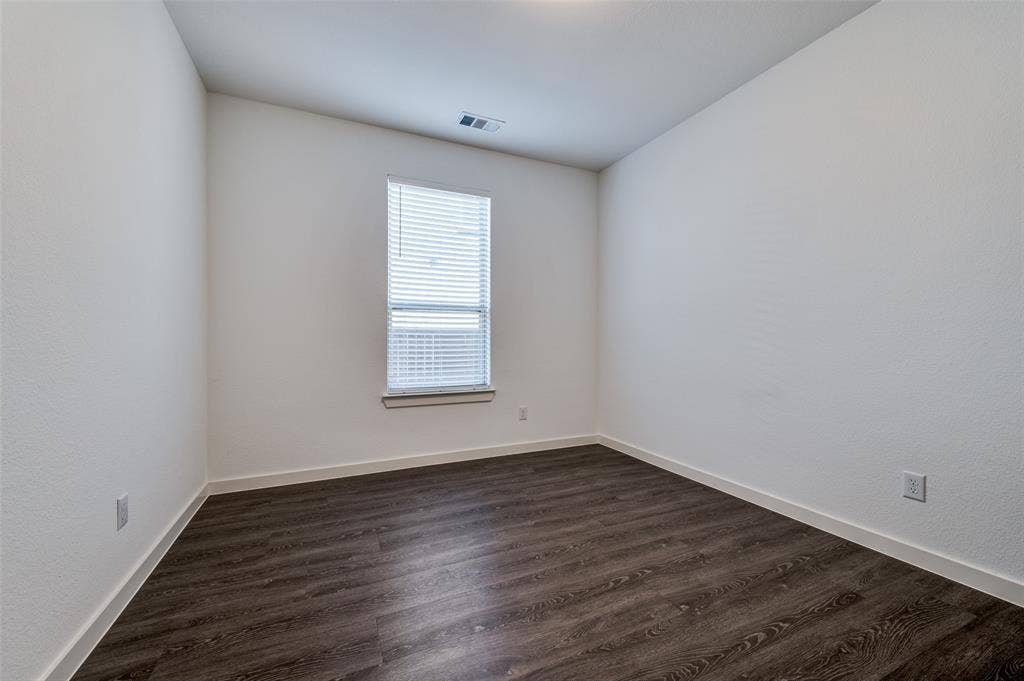 1520 Gelding Drive, Aubrey, TX 76227 Spare room featuring dark wood finished floors and baseboards