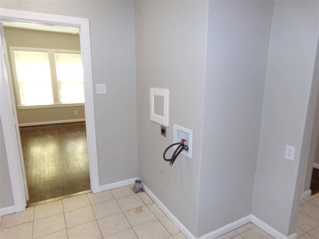 902 Centre Street, Dallas, TX 75208 Utility area featuring ceramic tile flooring, neutral wall paint, and dedicated washer and dryer hookups