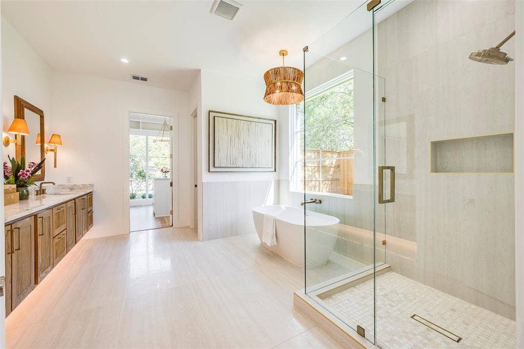 Floating white oak fluted double vanity, 72" soaking tub, oversized shower and Brizo faucets