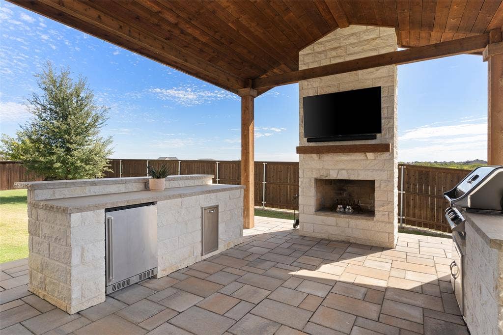 Outdoor Living w wood-burning fireplace and outdoor kitchen!