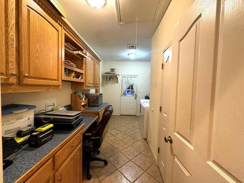 3700 NE County Road 0095, Corsicana, TX 75109 Built-in wood cabinetry, extended laminate countertop, and ceramic tile flooring
