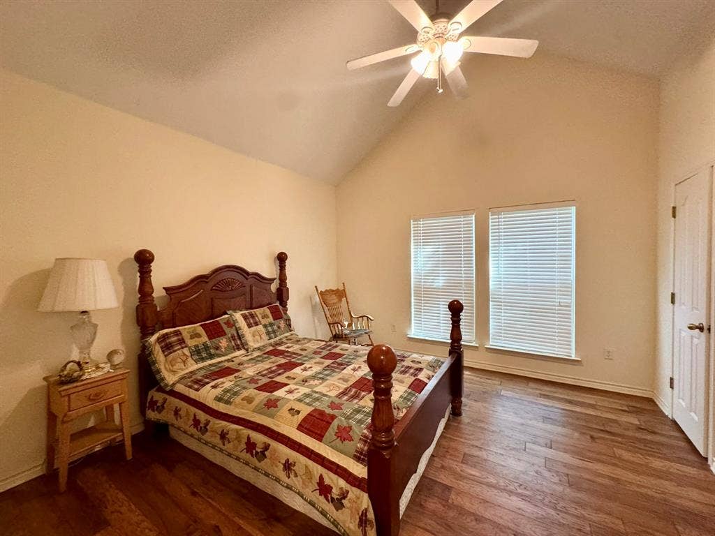 3700 NE County Road 0095, Corsicana, TX 75109 Vaulted ceilings, wood-finish flooring, dual windows with integrated blinds, and a multi-light ceiling fan