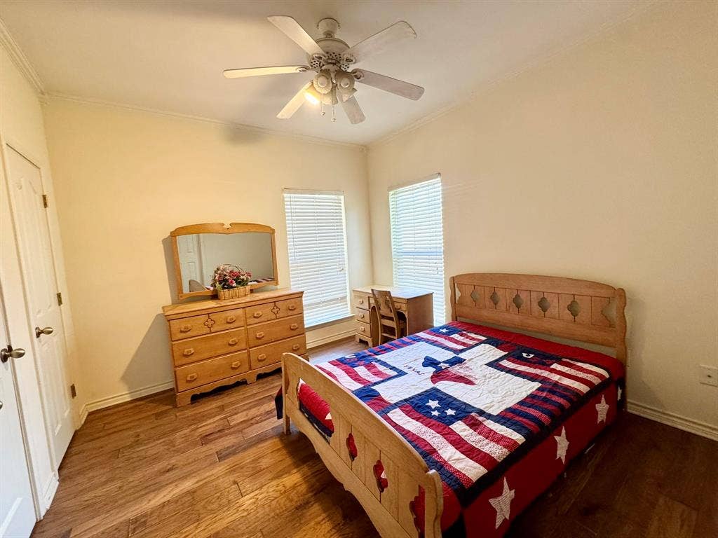 3700 NE County Road 0095, Corsicana, TX 75109 Wood-finish flooring, ceiling fan with integrated lighting, and dual windows with horizontal blinds