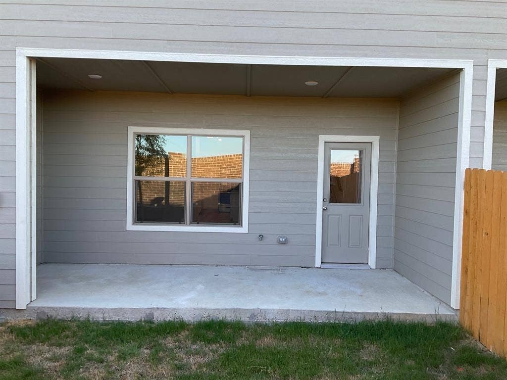 325 Stone Court, Princeton, TX 75407 Covered concrete patio featuring horizontal lap siding, recessed ceiling lighting, a single-pane window with white trim, and a glass-panel exterior door