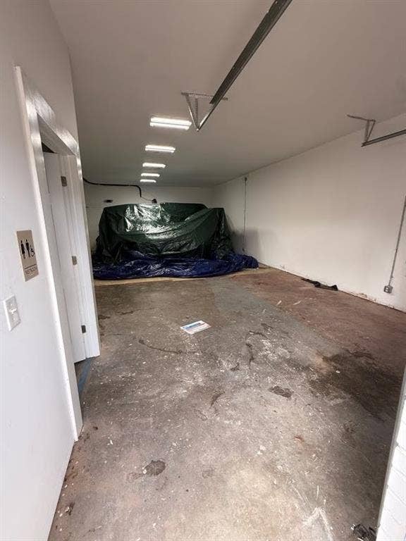 220 N Market Street, Shreveport, LA 71107 Enclosed garage area featuring white interior walls and recessed linear lighting