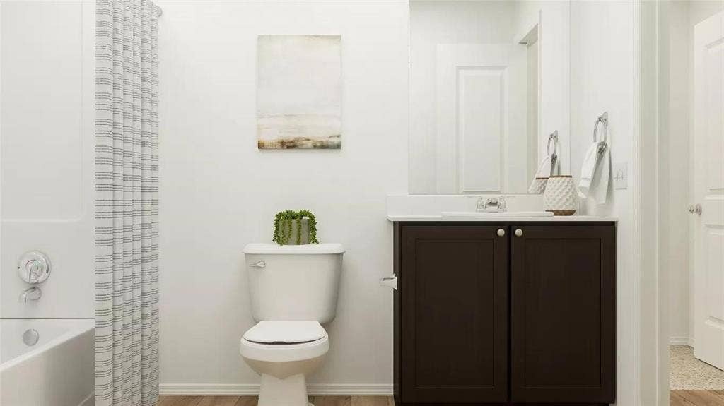 116 Radish Road, Princeton, TX 75407 Bathroom featuring a dark-finish vanity with a light-toned countertop, integrated basin, chrome-finished plumbing fixtures, and a shower-tub combination with a white surround
