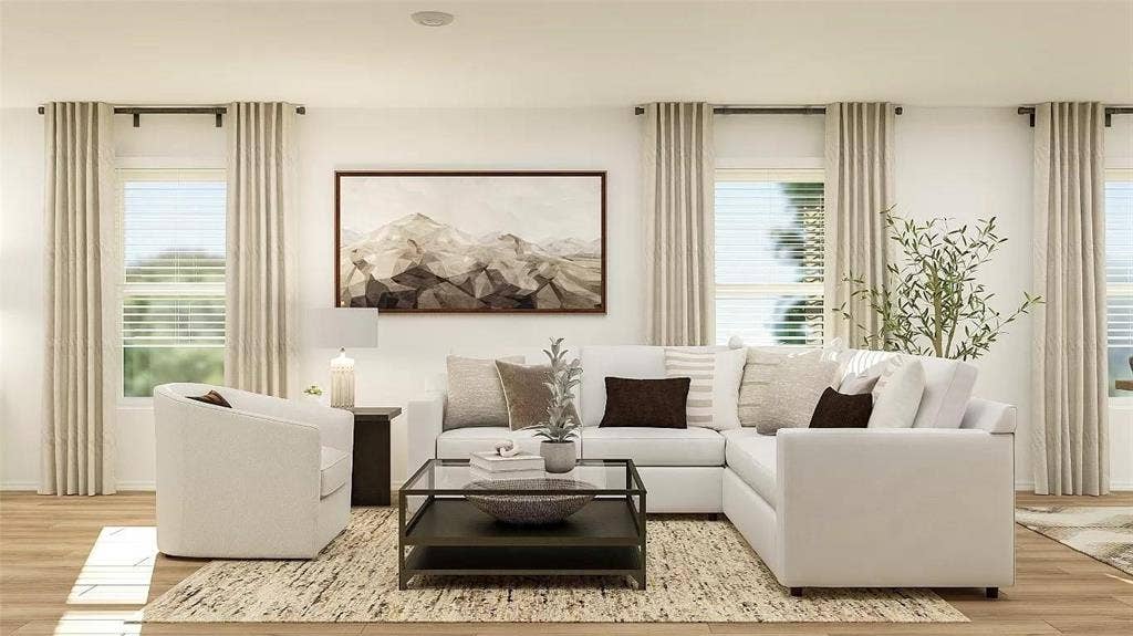 116 Radish Road, Princeton, TX 75407 Living area featuring wood-finish flooring, three oversized windows, and neutral wall tones