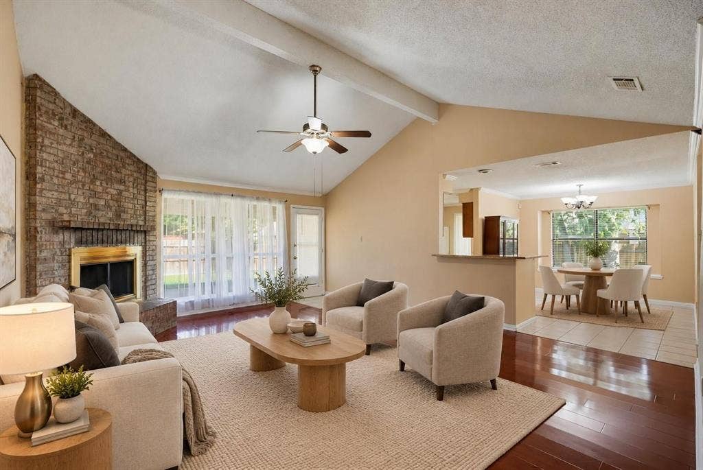 Vaulted ceilings, full-height masonry fireplace, and wood-finish flooring