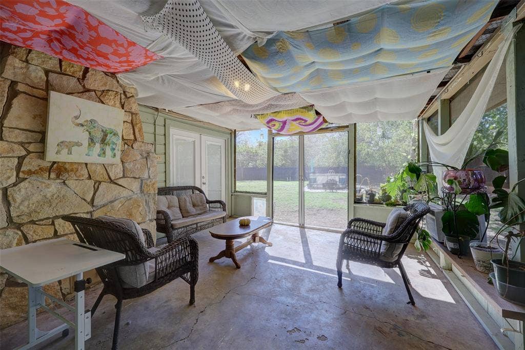 901 Elizabeth Boulevard, Granbury, TX 76048 Back of stone fireplace adds character to the patio. Retractable screen doors to the back yard