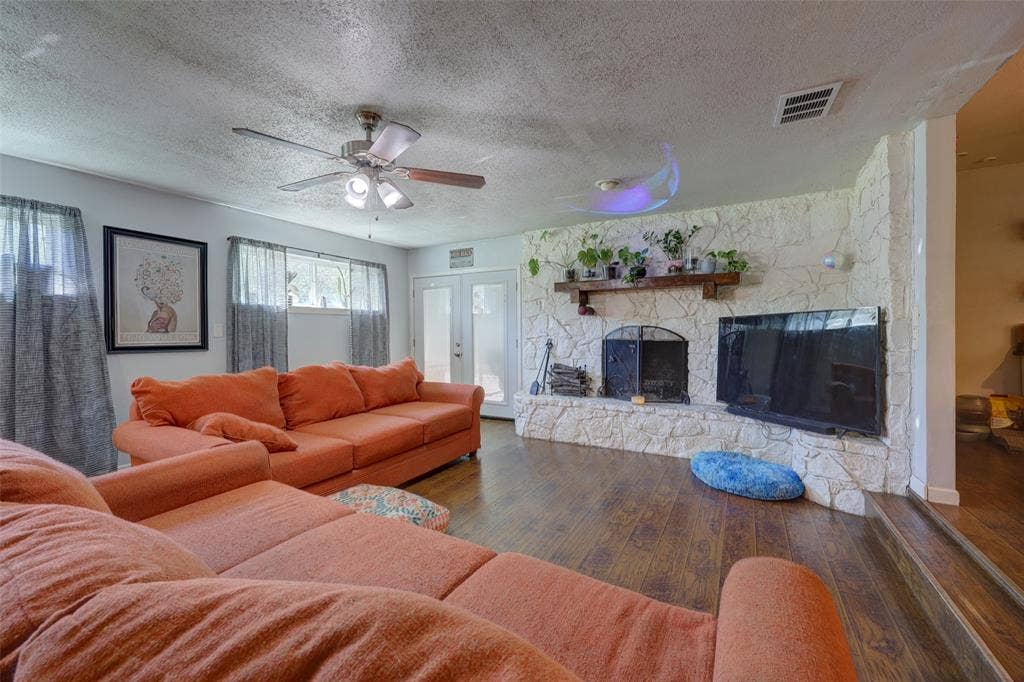 901 Elizabeth Boulevard, Granbury, TX 76048 Expansive stone wall boasts wood-burning fireplace and wood mantle