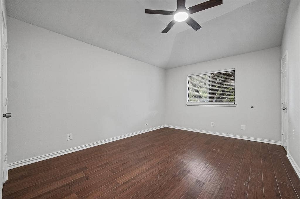 7929 Sunrise Drive, Watauga, TX 76148 Vaulted ceilings, wood-finish flooring, and a central ceiling fan with integrated lighting