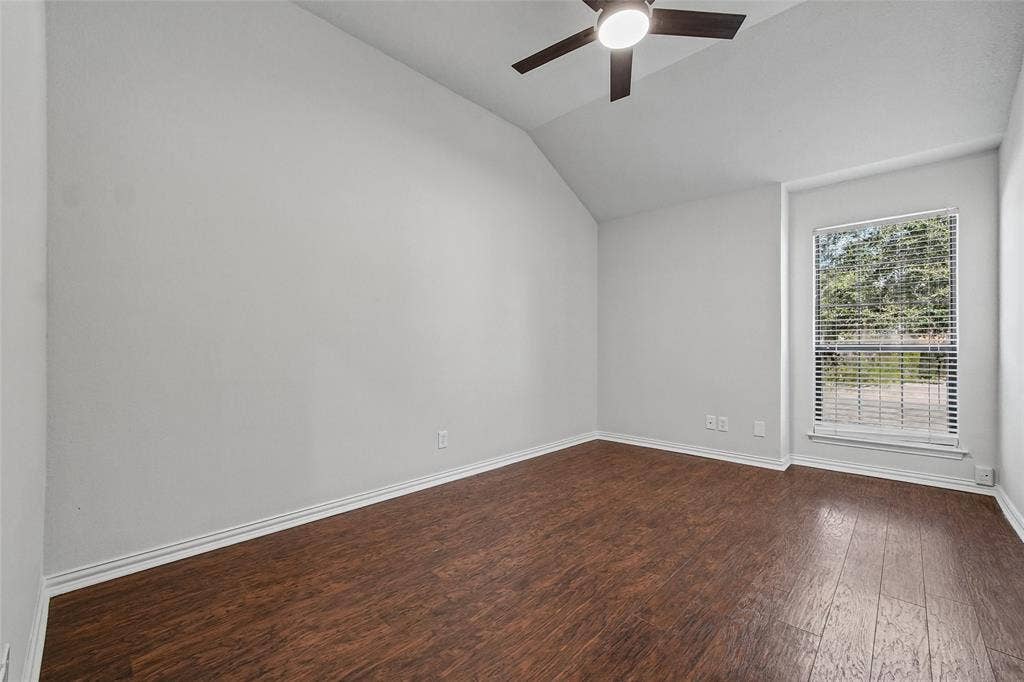 7929 Sunrise Drive, Watauga, TX 76148 Vaulted ceilings, wood-finish flooring, and a ceiling fan with integrated lighting