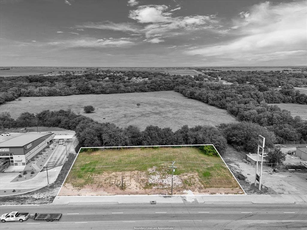 Vacant lot featuring direct street frontage, clear land area, and established perimeter vegetation