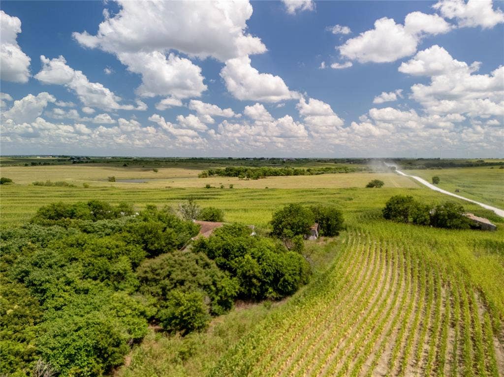 Aerial view of sparsely populated area with large plots for crops