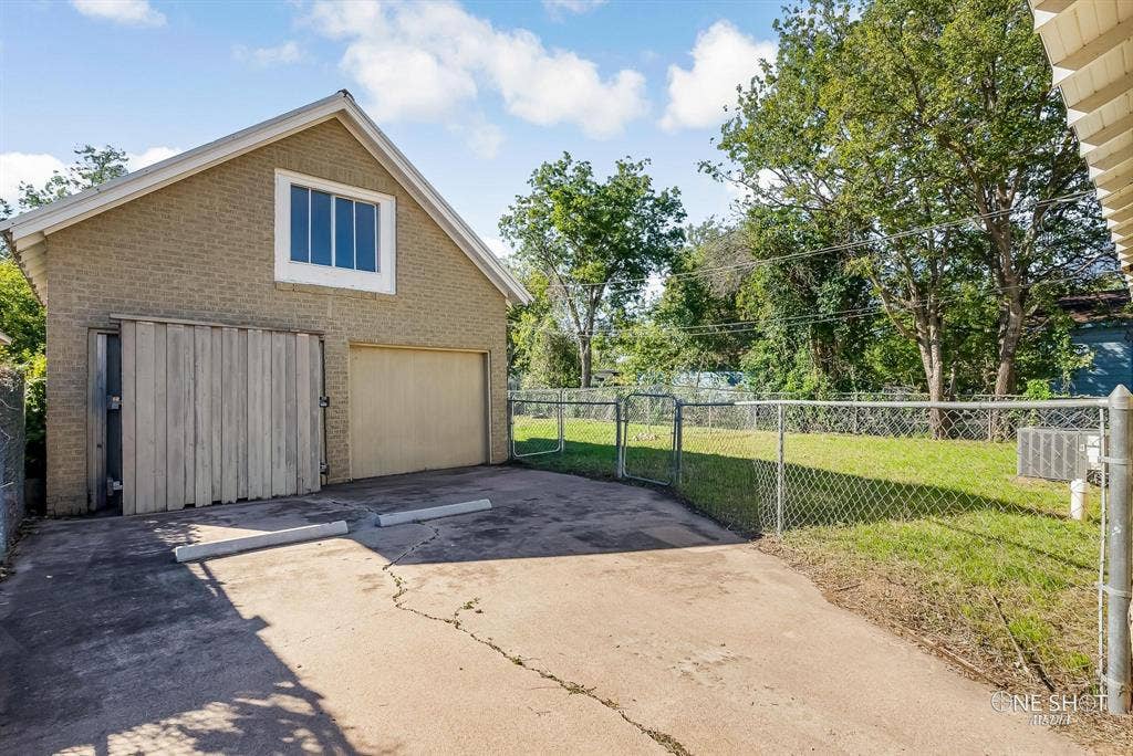 View of side of home featuring a yard