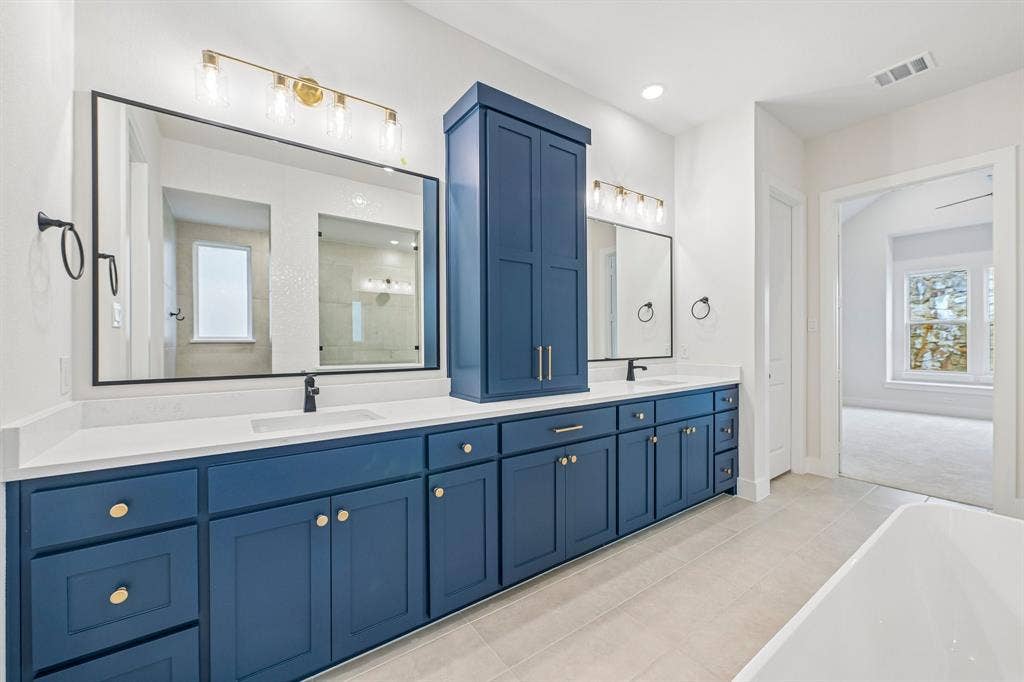 4012 Bentsen Street, McKinney, TX 75071 Featuring vibrant cabinetry that is as functional as it is beautiful, this owner's bath is a dream come true!