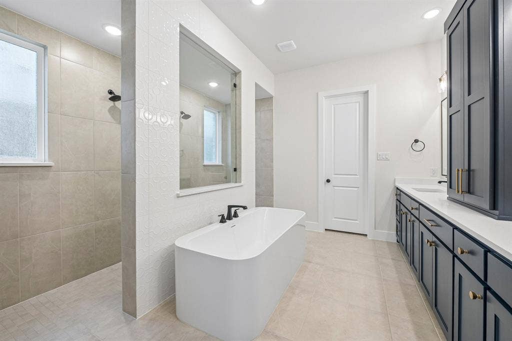4012 Bentsen Street, McKinney, TX 75071 You'll enjoy a spa like experience every day in our signature owner's bath featuring a double walk through shower with free standing tub.