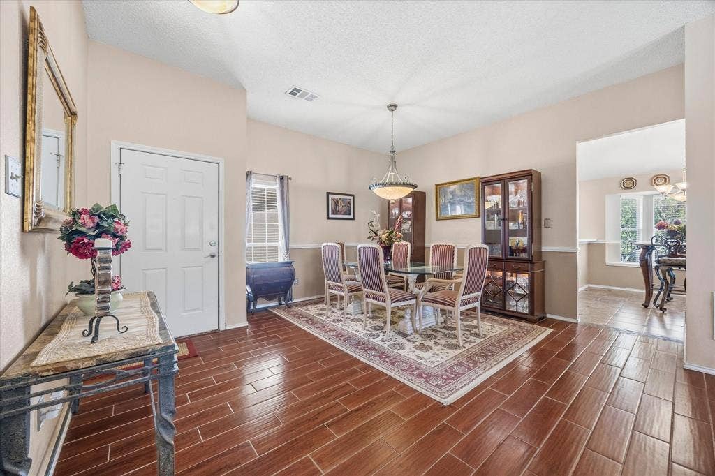 6412 Bluebonnet Drive, Rowlett, TX 75089 Lovely entry opens onto dining and living areas