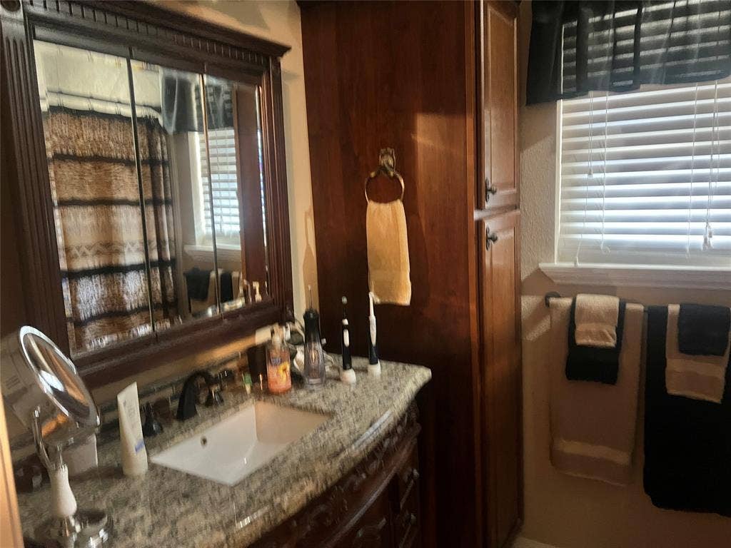 2612 Quail Run Drive, Plano, TX 75075 Master bath has a custom vanity with granite top.