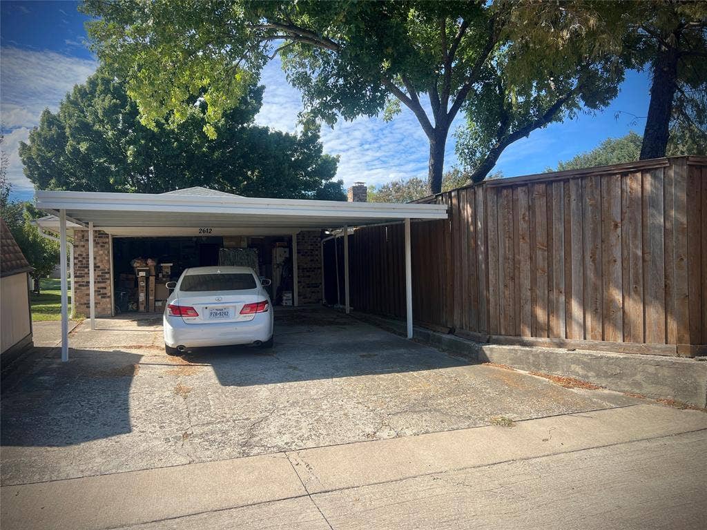 2612 Quail Run Drive, Plano, TX 75075 Carport behind the garage has two spaces, and provides extra covered parking.