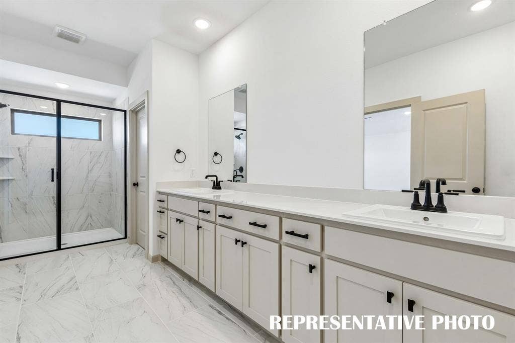 612 Taylor Parkway, Celina, TX 75009 With ample room for two and a lovely walk in shower, this owner's bath is a dream come true! REPRESENTATIVE PHOTO