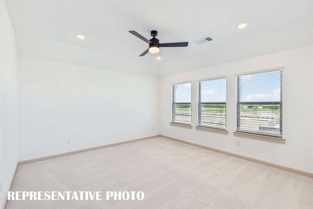 612 Taylor Parkway, Celina, TX 75009 Featuring plush carpeting and a wall of windows, this wonderful owner's suite was designed for rest and relaxation. REPRESENTATIVE PHOTO