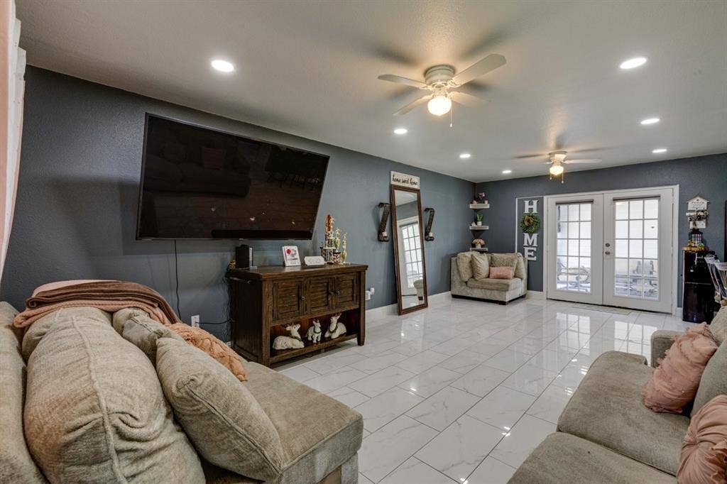 Polished tile flooring, recessed ceiling lighting, dual ceiling fans, and French doors featuring glass panes