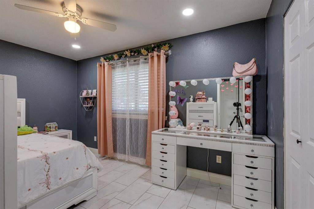 Interior space featuring tile flooring, ceiling fan with light fixture, recessed lighting, and dual-pane window