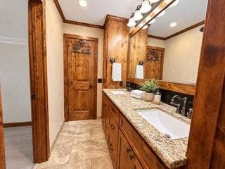 13672 County Road 2915, Eustace, TX 75124 Bathroom featuring custom wood cabinetry, stone-finish countertop with an integrated rectangular sink, stone-tile flooring, and a large wood-framed mirror