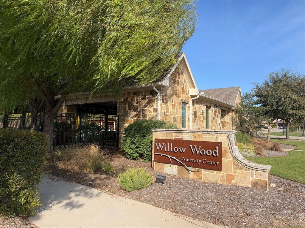5313 Pratt Circle, McKinney, TX 75071 Stone-veneer amenity center featuring a covered pavilion, paved walkway, and landscaping