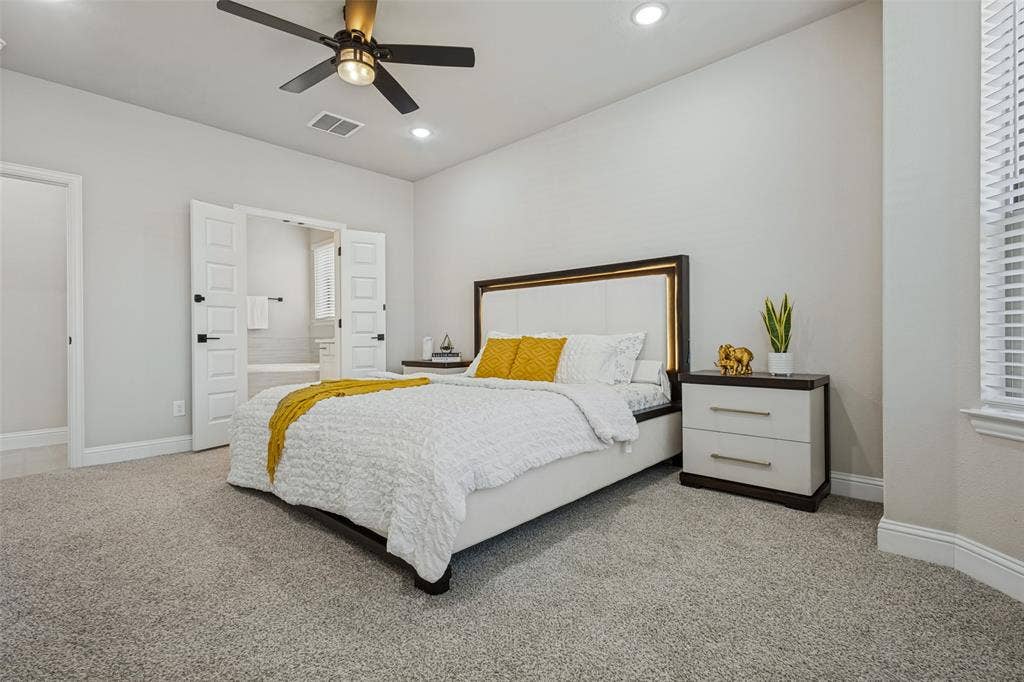 5313 Pratt Circle, McKinney, TX 75071 Neutral-toned carpeted interior featuring recessed lighting, a modern ceiling fan with integrated lighting, and white multi-panel double doors