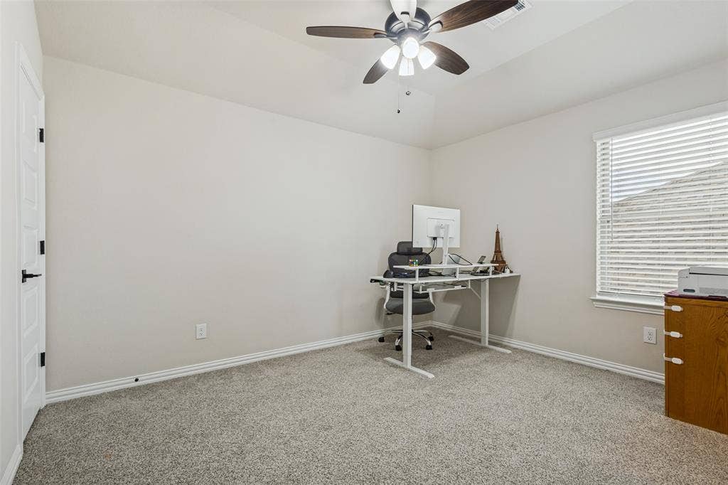 5313 Pratt Circle, McKinney, TX 75071 Room featuring neutral wall tones, carpeted flooring, a tray ceiling, a multi-blade ceiling fan with integrated lighting, and a window with horizontal blinds